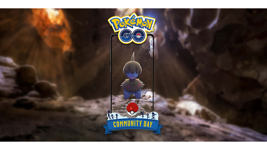 Pokemon Landscape 桌布 壁紙 — 一部智慧型手機在岩石洞穴中顯示一隻藍色和棕色的寶可夢，背景有火焰和社群日橫幅。