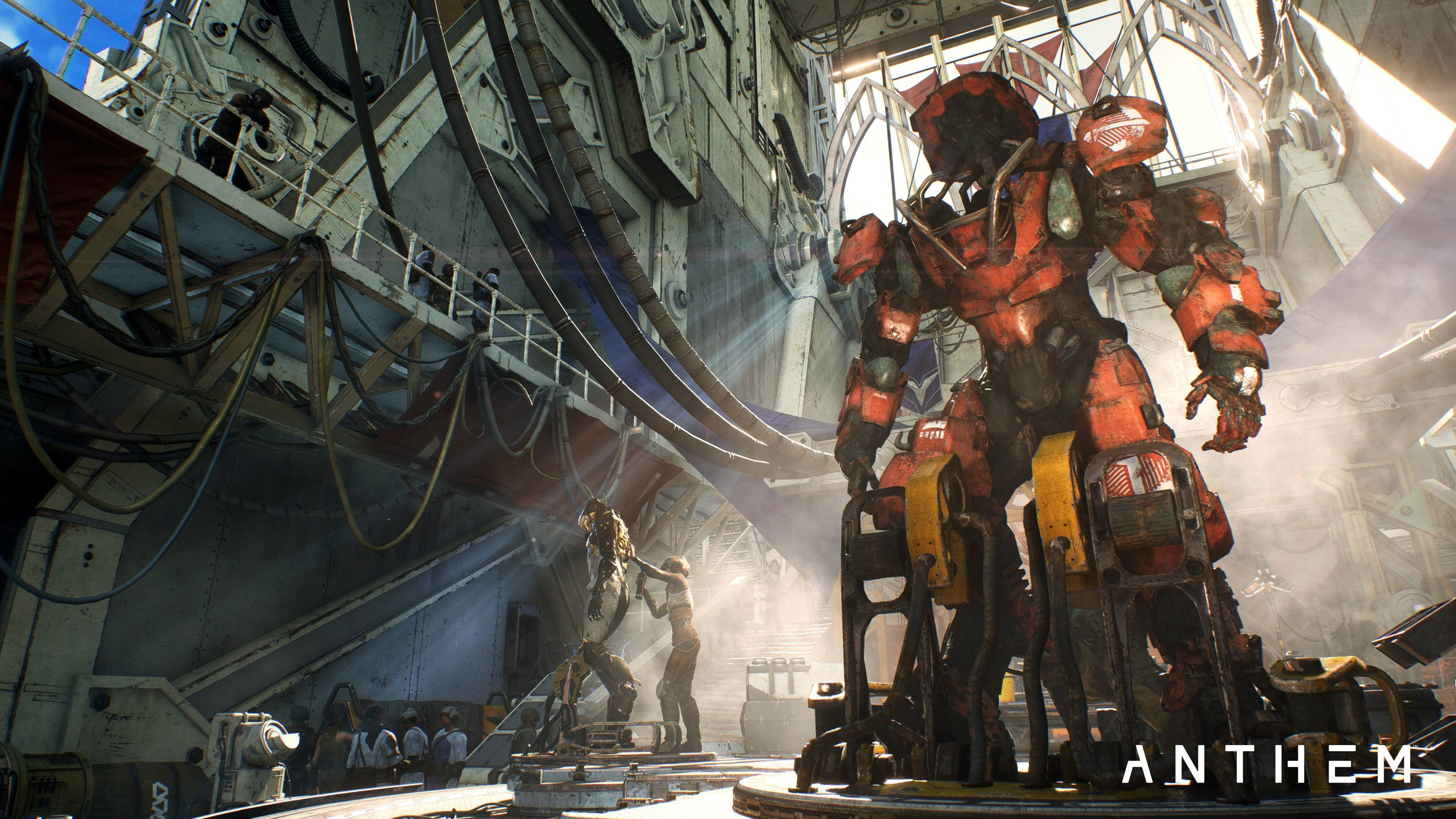 anthem 4K 桌布 壁紙 — 一部高聳的紅色裝甲機甲站在陽光普照的工業機庫中，工人們正在附近照料另一部機甲。