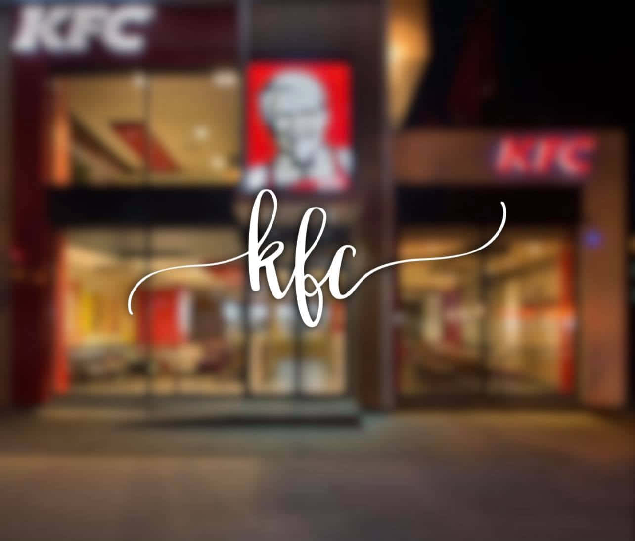 肯德基 桌布 壁紙 — 一間KFC餐廳的模糊夜間照片，帶有發光招牌和突出的白色草書KFC標誌疊加。
