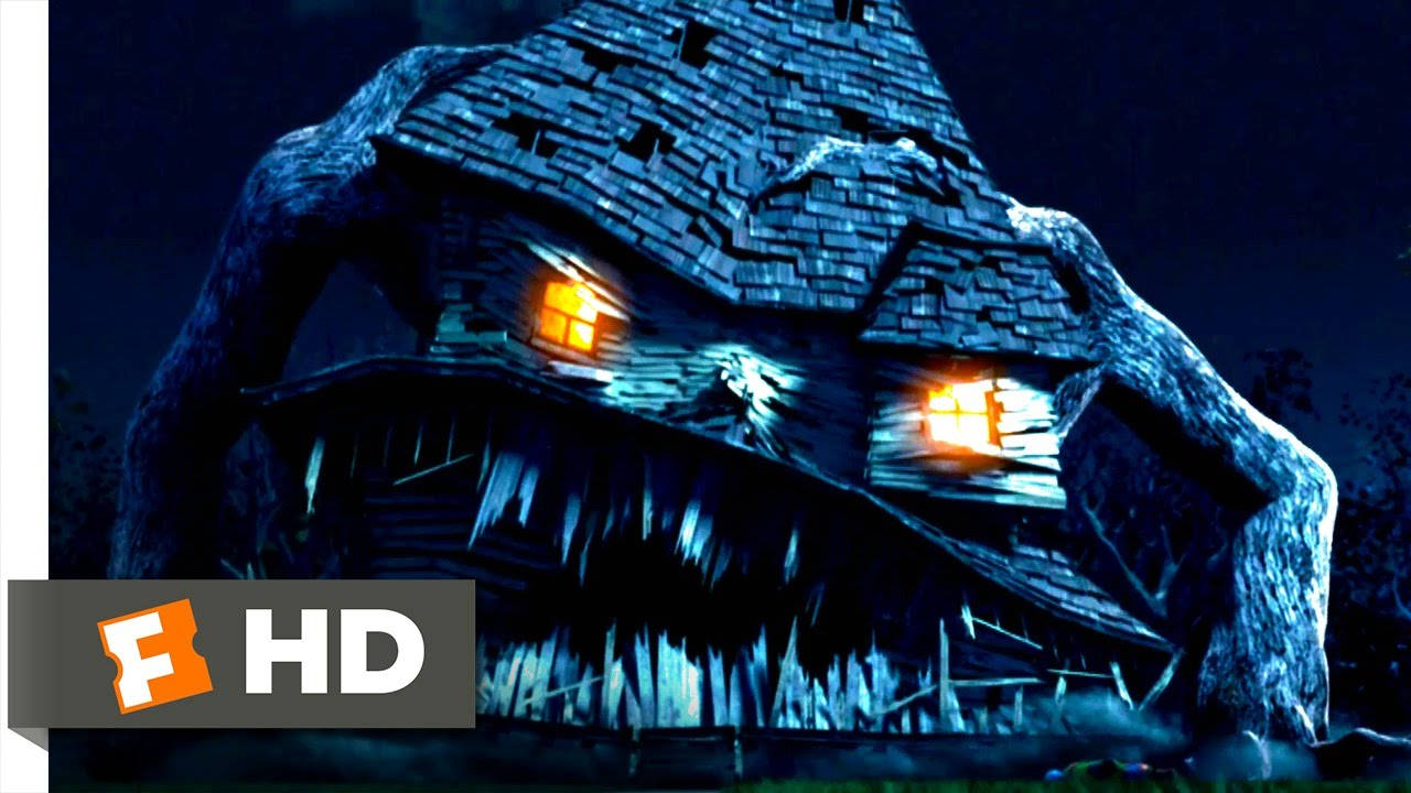 Monster House 桌布 壁紙 — 一間帶有眼睛形狀發光窗戶和鋸齒狀屋頂線、夜間像怪物面孔的恐怖房屋。