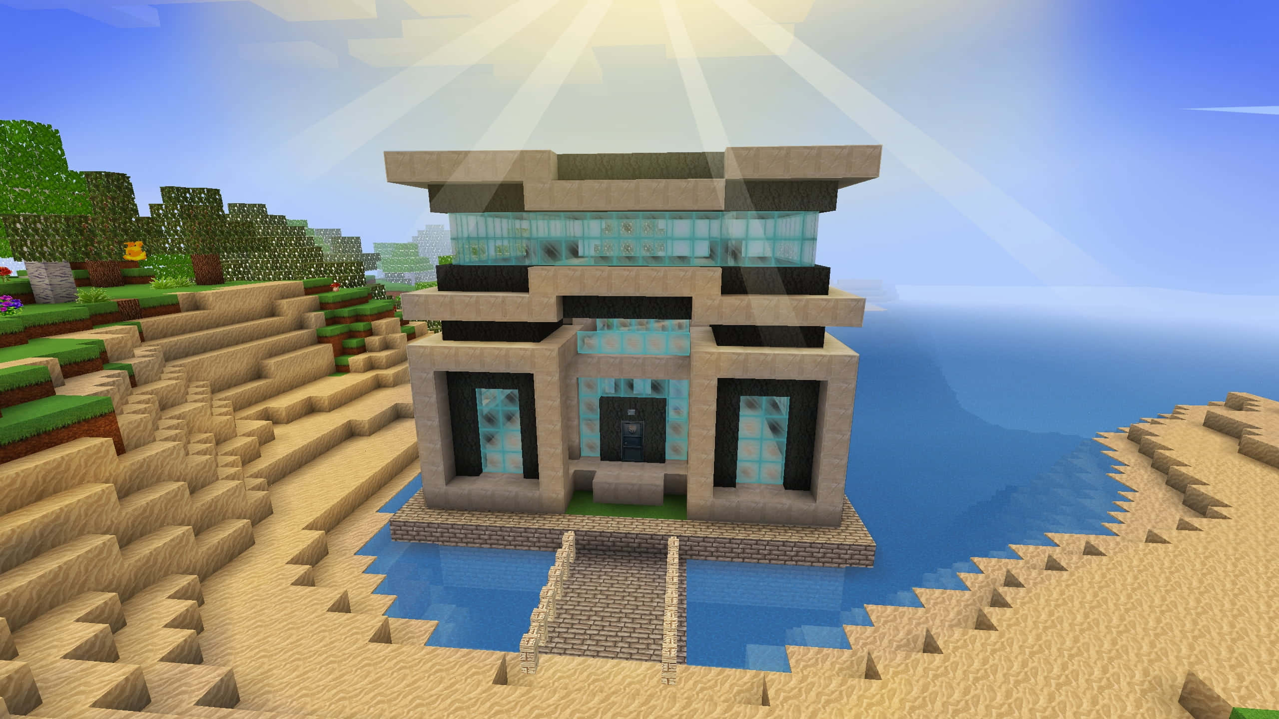 Minecraft Adventure 桌布 壁紙 — 一間現代Minecraft房屋，配有玻璃窗和石塊，坐落於沙灘上，旁邊是海水，在明亮的陽光下。