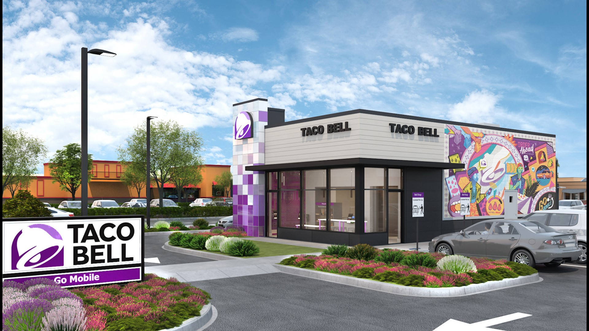 Taco Bell 桌布 壁紙 — 一間現代化的Taco Bell餐廳，帶有鮮豔的紫色點綴和色彩繽紛的壁畫藝術，在明亮的藍天和散落的雲朵下。