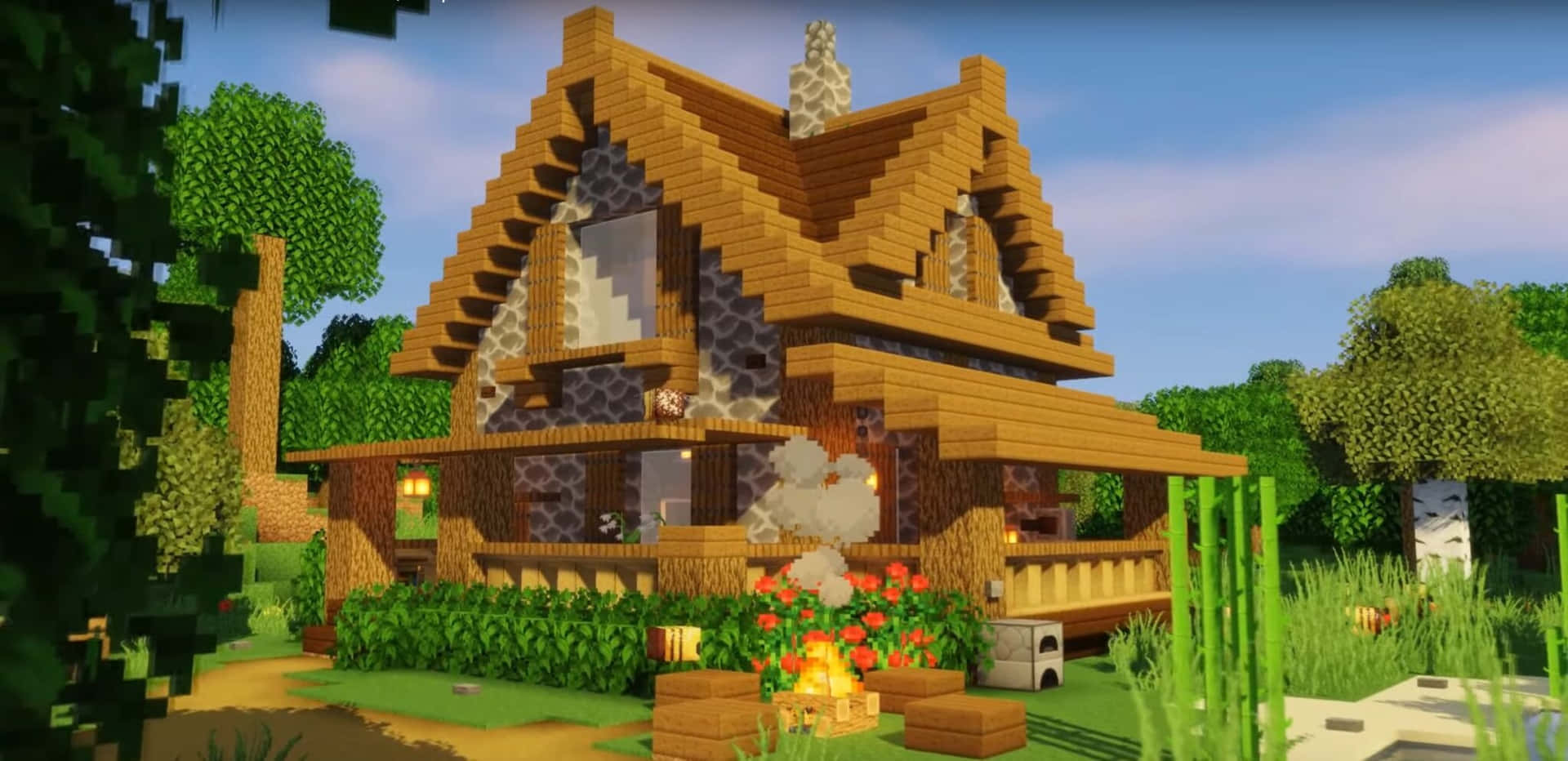 Minecraft Survival 桌布 壁紙 — 一間舒適的像素風木屋，帶有石頭裝飾，前面有溫暖的火焰，周圍是綠樹和紅花，在清澈的藍天下。