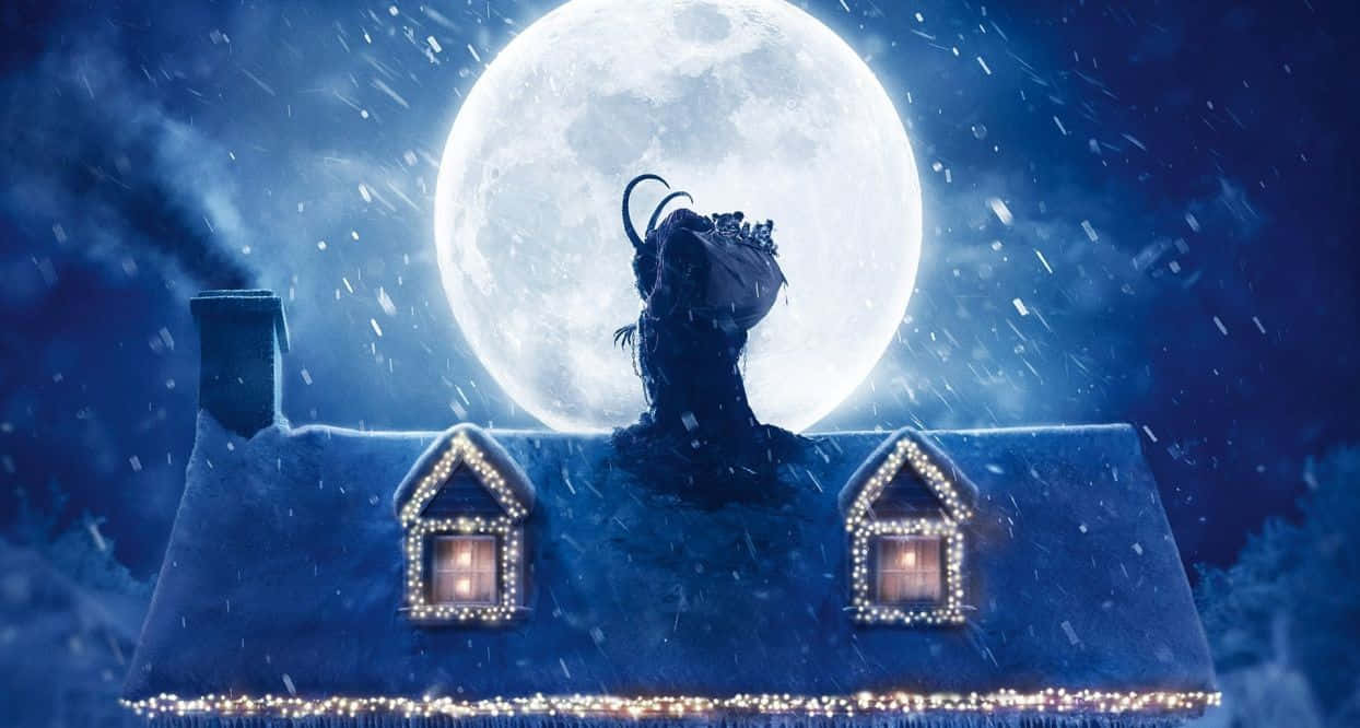 Dark Christmas 桌布 壁紙 — 一間被雪覆蓋的房子，窗戶閃爍著光芒，坐在巨大的滿月下，雪花飄落，構成一個神奇的冬夜場景。