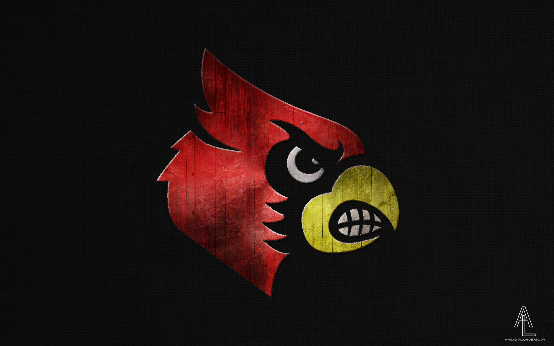 Cardinals 桌布 壁紙 — 一隻兇猛的紅色紅雀吉祥物，黃色喙和鋒利牙齒，在深色紋理背景上強烈凝視。