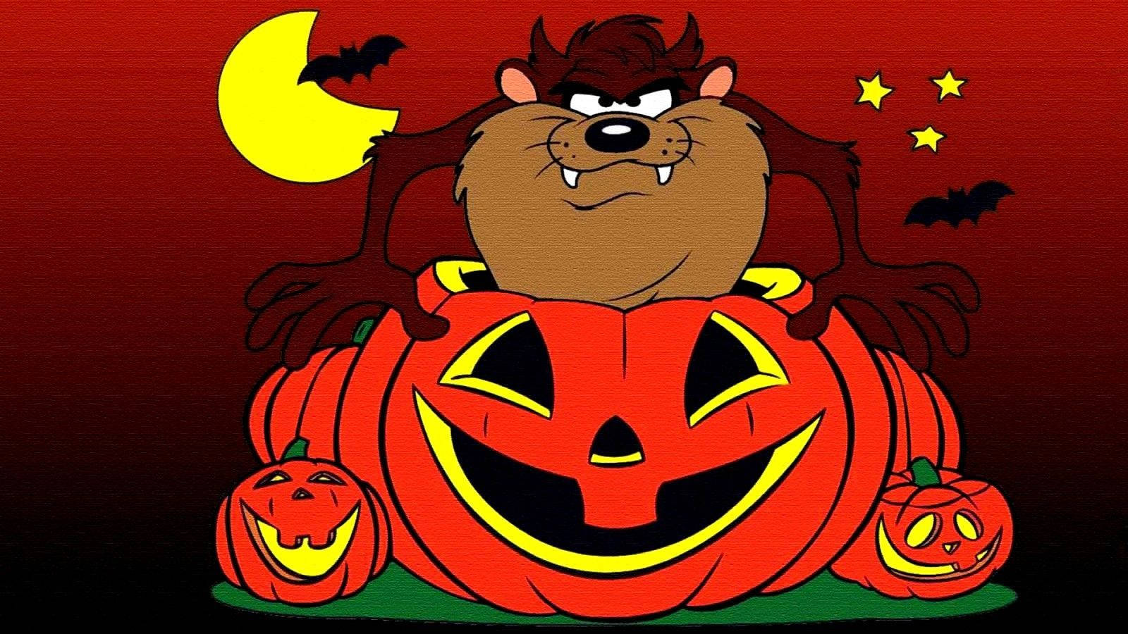 tasmanian devil 桌布 壁紙 — 一隻卡通塔斯馬尼亞惡魔坐在巨型傑克南瓜燈上，蝙蝠和彎月在詭異的萬聖節夜晚場景中。