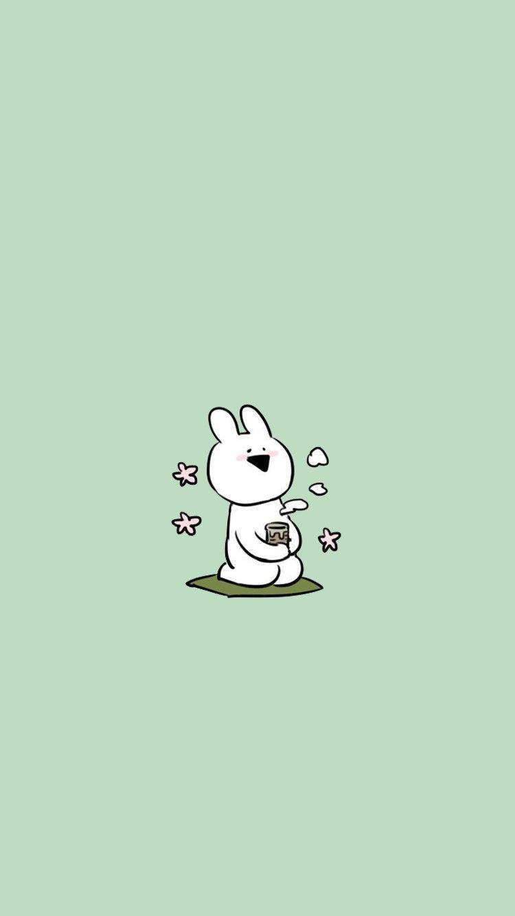 Cartoon 桌布 壁紙 — 一隻可愛的白色卡通兔子坐在綠色的 patch 上，拿著一個有蒸氣和粉紅色花朵漂浮的杯子。