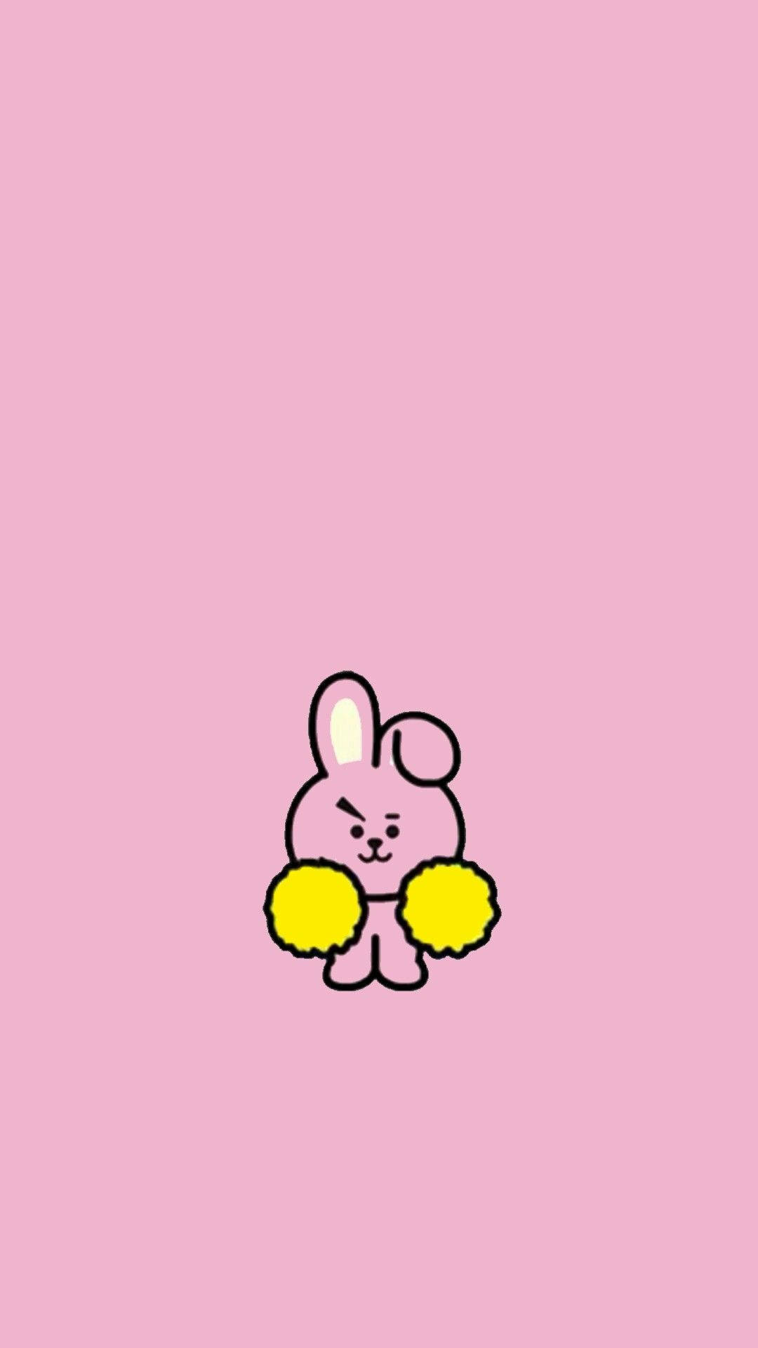 BT21 桌布 壁紙 — 一隻可愛的粉紅色卡通兔子，拿著黃色絨球，站在純粉紅色背景中央。