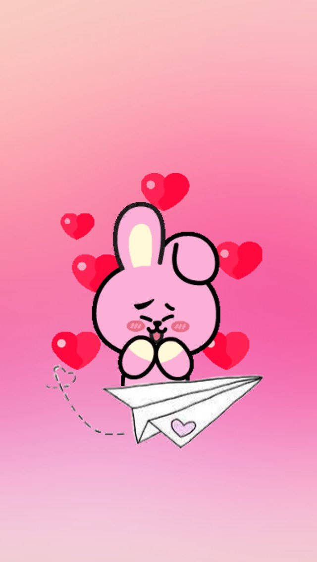 Cooky Bt21 桌布 壁紙 — 一隻可愛的粉紅色卡通兔子，臉頰紅潤，坐在紙飛機上，周圍漂浮著紅色愛心，背景是漸層粉紅色。