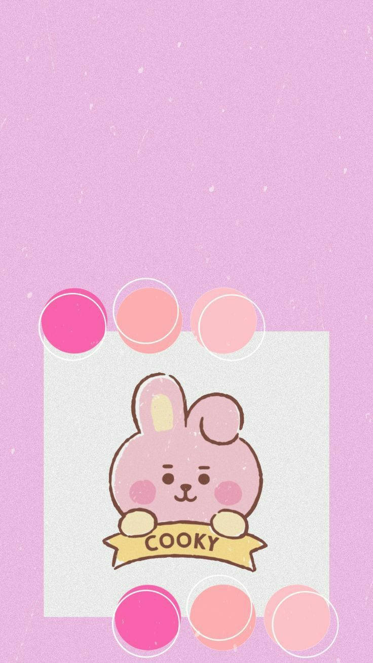 Cooky Bt21 桌布 壁紙 — 一隻可愛的粉紅色卡通兔子拿著寫有 cooky 的橫幅，背景是柔和的薰衣草色和漂浮的粉彩圓圈。