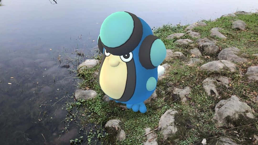 Lake 桌布 壁紙 — 一隻大型藍色和藍綠色卡通企鵝站在一個平靜的湖邊，周圍有岩石和綠草。