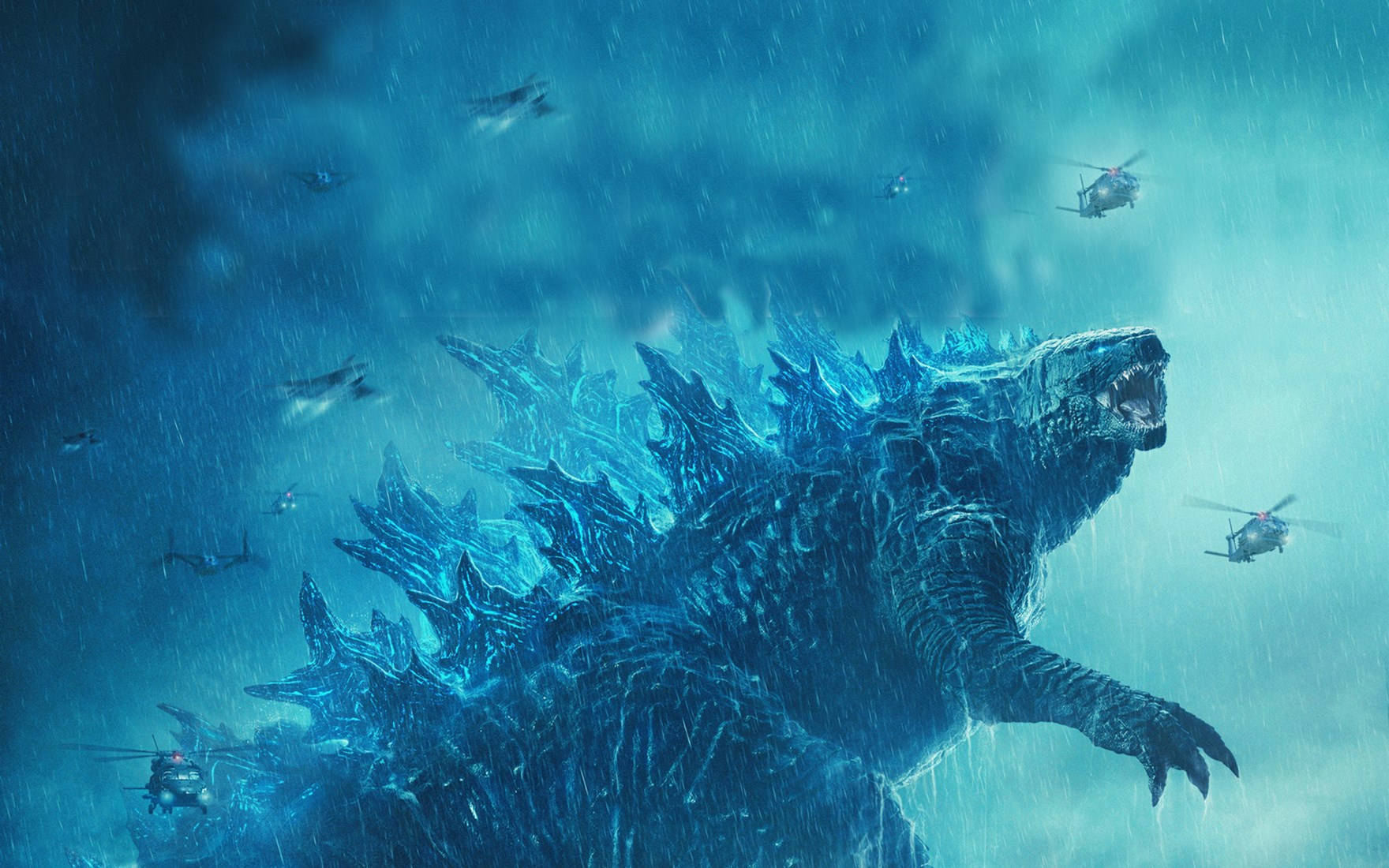 shin godzilla 桌布 壁紙 — 一隻巨大的藍色哥吉拉在暴雨中咆哮，軍用直升機在暴風雨的天空中圍繞著他。