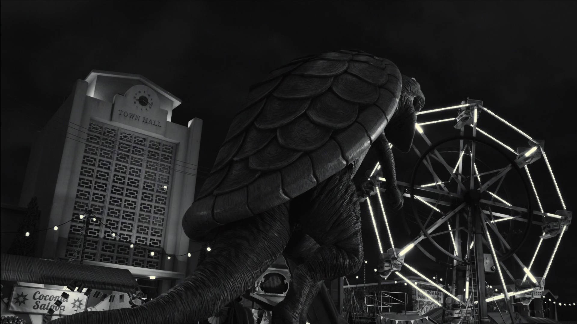 Frankenweenie 桌布 壁紙 — 一隻巨大的裝甲恐龍在夜晚籠罩著發光的摩天輪和市政廳，呈現出鮮明的黑白場景。