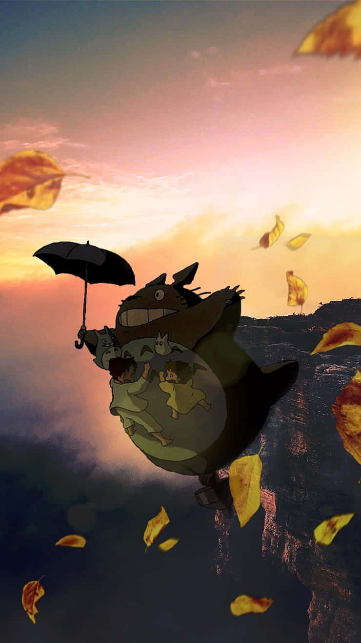 Floating 桌布 壁紙 — 一隻巨大的龍貓在夕陽天空飛翔，帶著孩子和一把傘，金色樹葉在他們周圍旋轉。
