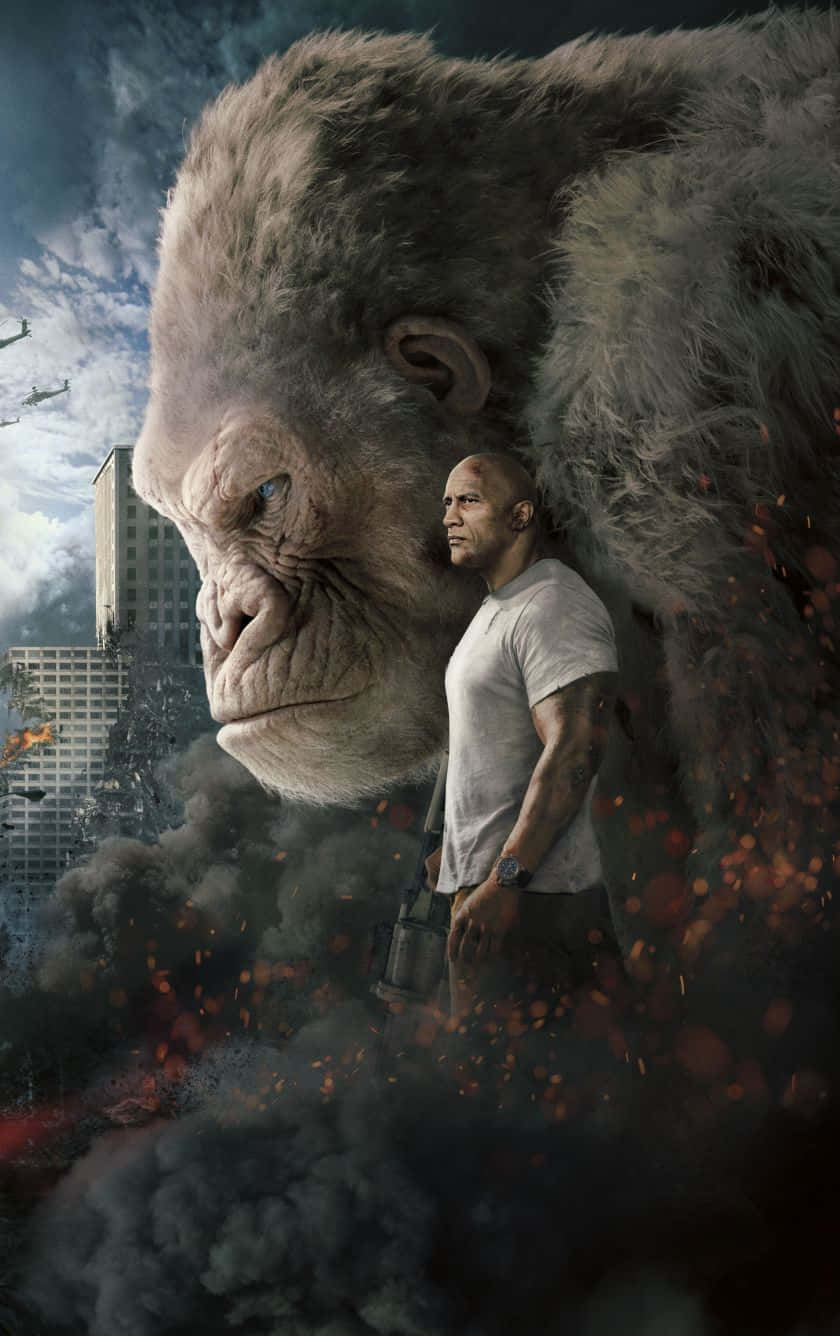 Gorilla 桌布 壁紙 — 一隻巨猿站在一個男人旁邊，背景是煙霧和火焰的廢墟城市景觀。