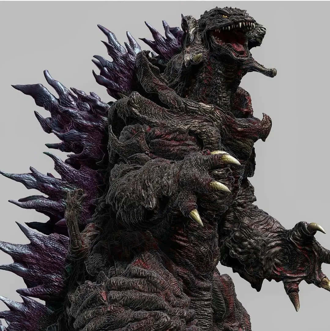 Godzilla 2000 桌布 壁紙 — 一隻帶有深色紋理皮膚和發光眼睛的威脅性哥吉拉，對著純灰色背景咆哮。