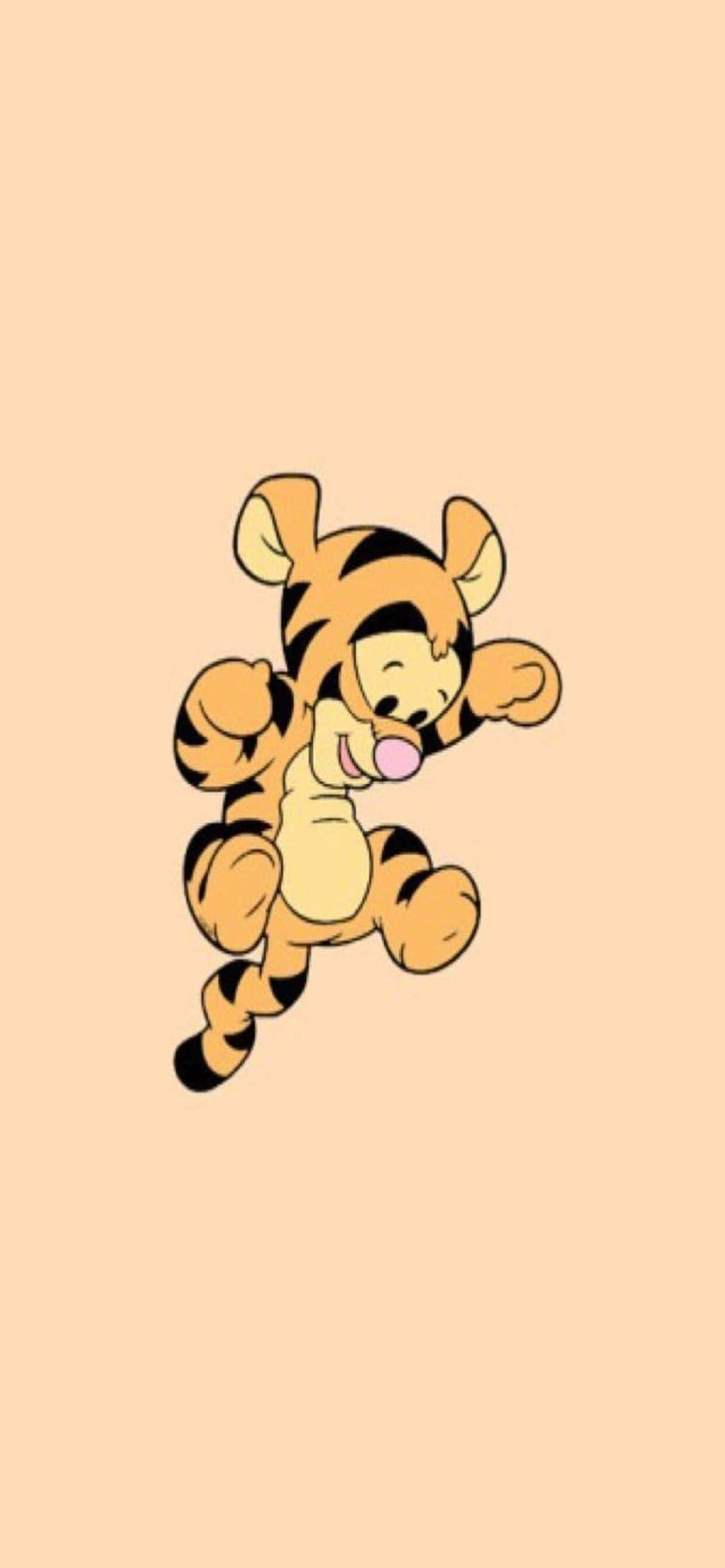 iPhone Xs Max Disney 桌布 壁紙 — 一隻帶有黑色條紋的快樂卡通老虎幼崽在純色蜜桃背景上歡快地跳躍。
