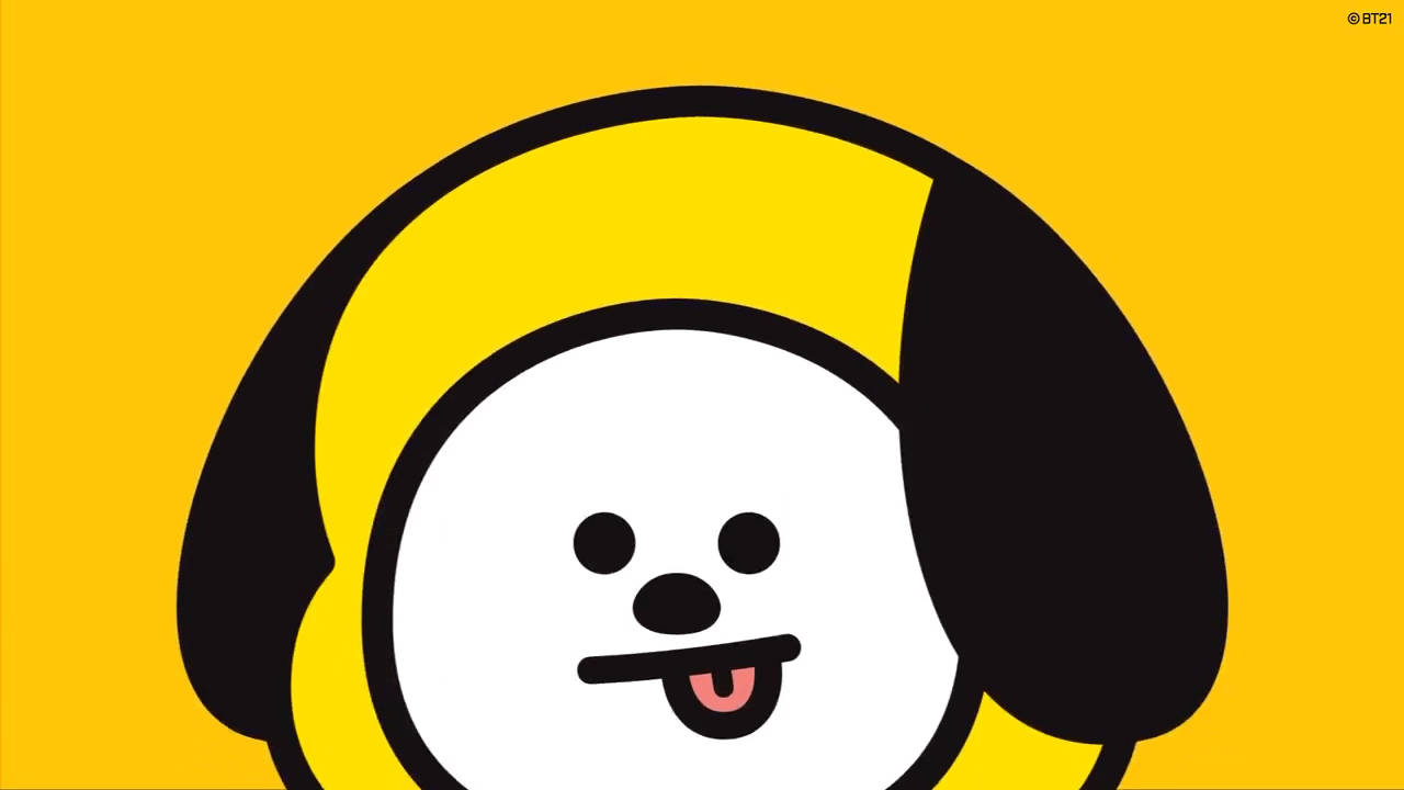 Chimmy 桌布 壁紙 — 一隻快樂的卡通狗，有黑色耳朵和粉紅色舌頭，在純黃色背景上伸出舌頭。