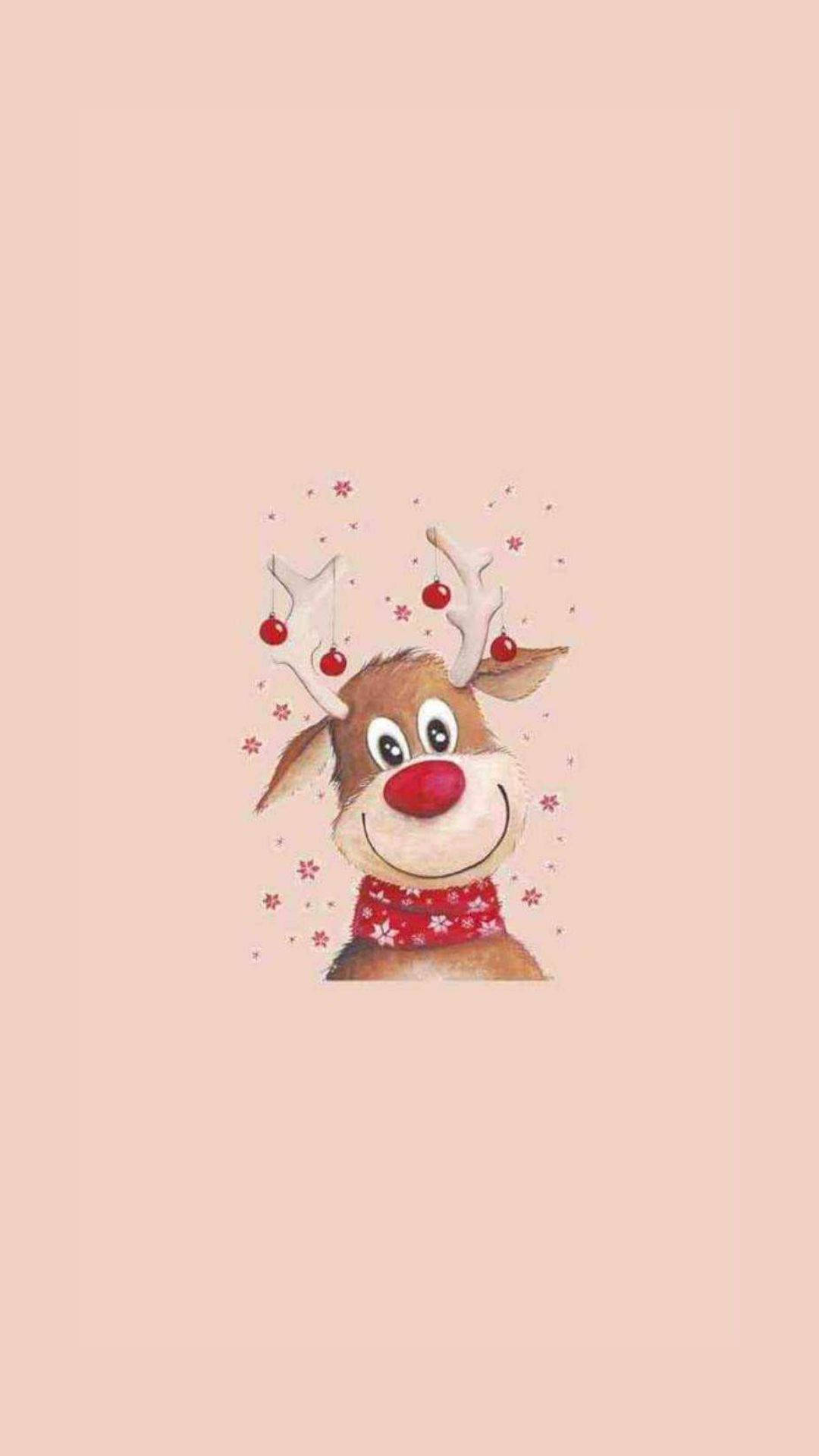 Kawaii Christmas 桌布 壁紙 — 一隻快樂的卡通馴鹿，紅鼻子和節日圍巾，在柔和的粉紅色背景上微笑，周圍散落著雪花。