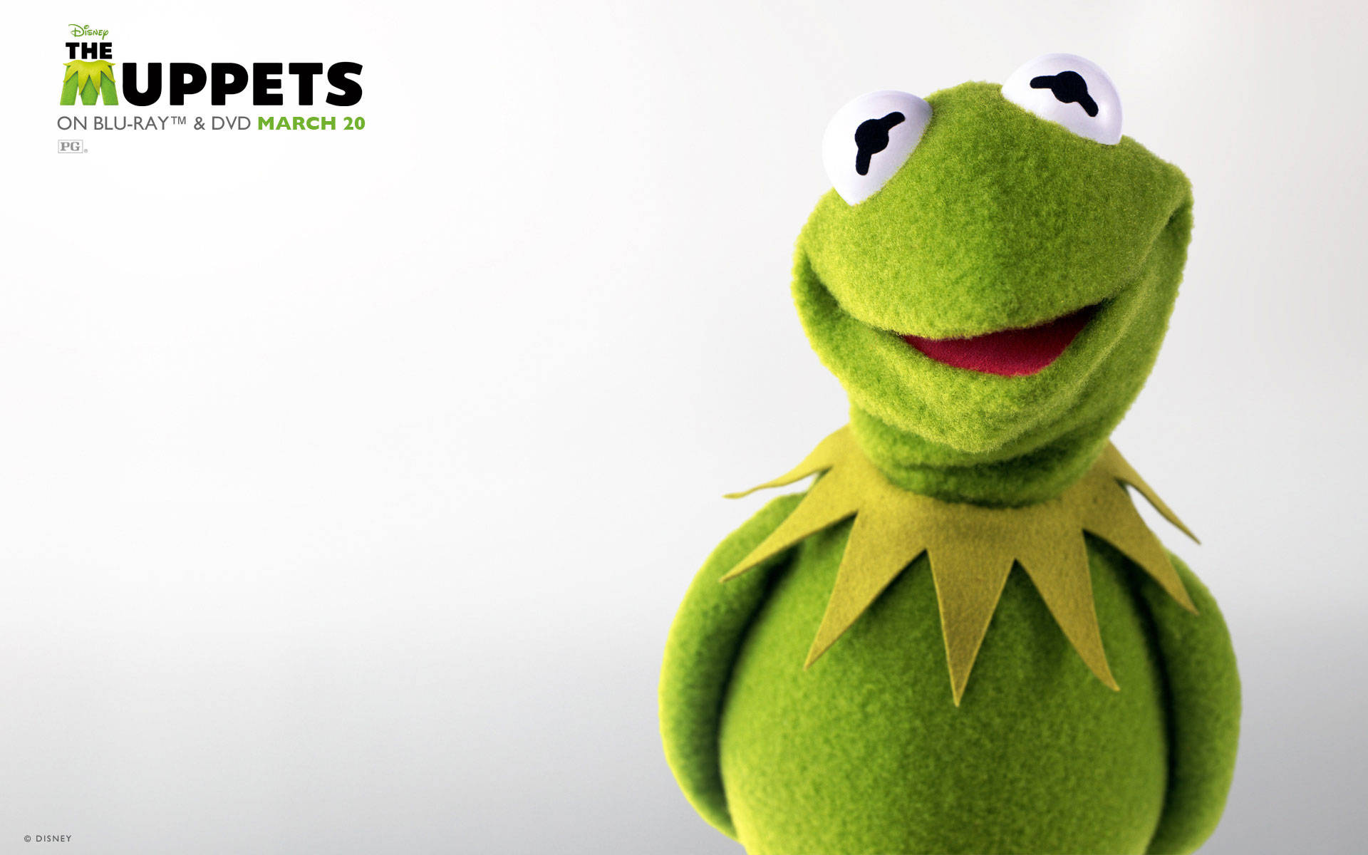 kermit 桌布 壁紙 — 一隻快樂的綠色氈布青蛙木偶，有著白色大眼睛和黃色領子，在純白背景上微笑。