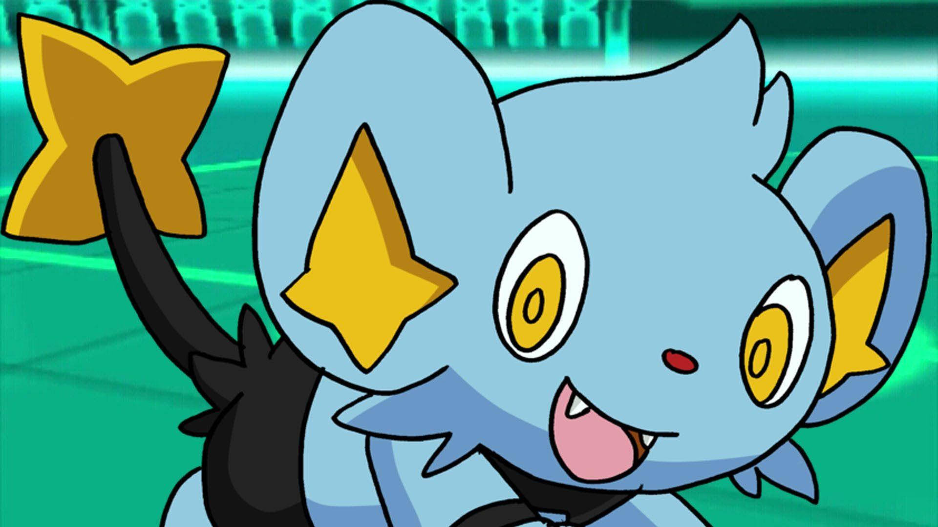Shinx 桌布 壁紙 — 一隻快樂的藍色動漫生物，有著黃色星形耳朵和星形尾巴，在發光的綠色背景前微笑。