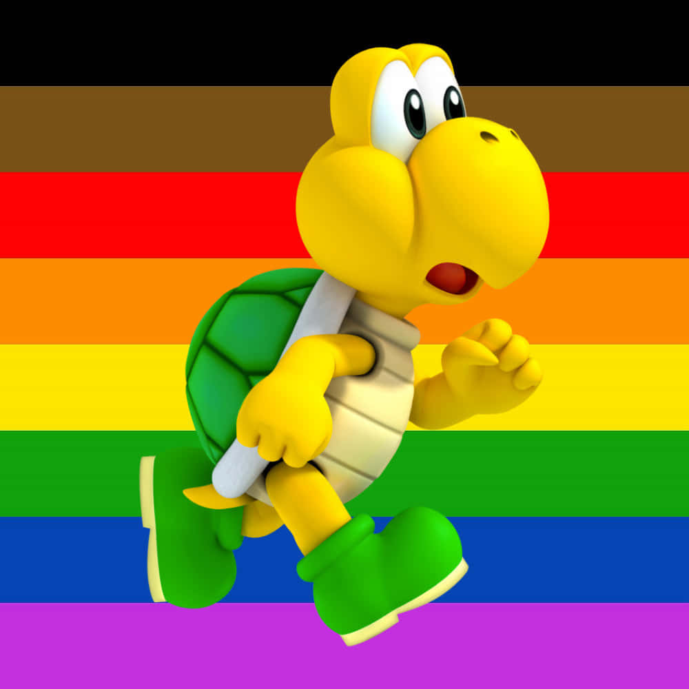 Koopa Troopa 桌布 壁紙 — 一隻快樂的黃色Koopa Troopa在充滿活力的彩虹旗背景下精力充沛地奔跑。