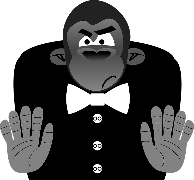Gorilla 桌布 壁紙 — 一隻憤怒的卡通大猩猩穿著燕尾服，繫著白色領結，雙手張開，背景為黑色。