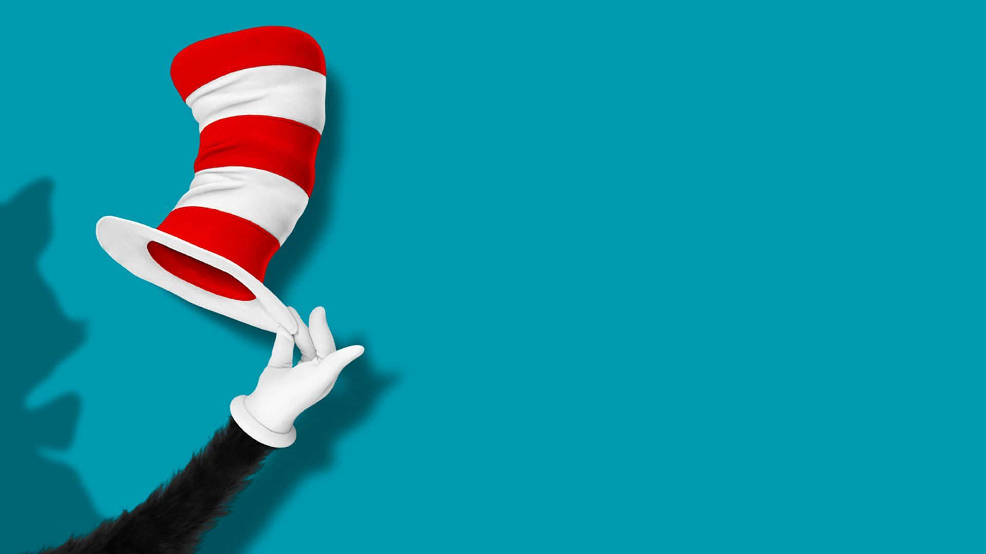 Dr Seuss 桌布 壁紙 — 一隻戴著白色手套的手，在純青色背景上拿著一頂紅白條紋帽子，帶有柔和陰影。