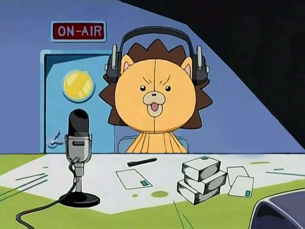 Bleach Kon 桌布 壁紙 — 一隻戴著耳機的卡通獅子在標有 'ON-AIR' 的電台錄音室中，充滿活力地對著麥克風廣播。