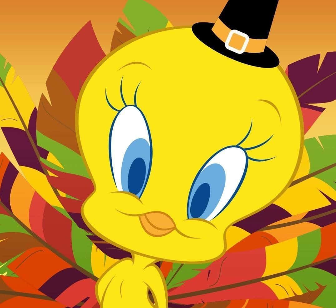 Tweety Bird 桌布 壁紙 — 一隻戴著黑色朝聖者帽的快樂黃色卡通鳥，周圍環繞著色彩繽紛的秋葉。