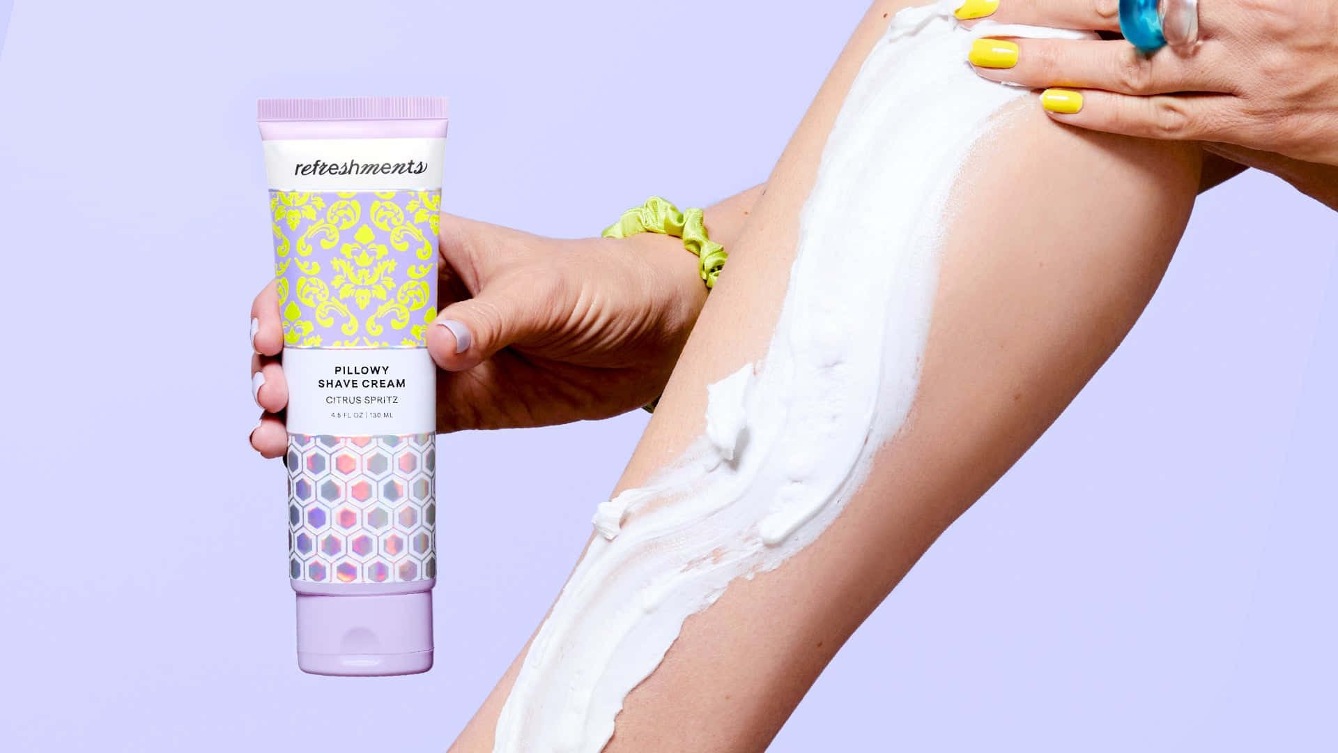 Shaving Cream 桌布 壁紙 — 一隻手將乳狀刮鬍凝膠塗抹在腿上，同時將產品管對著柔和的薰衣草背景。