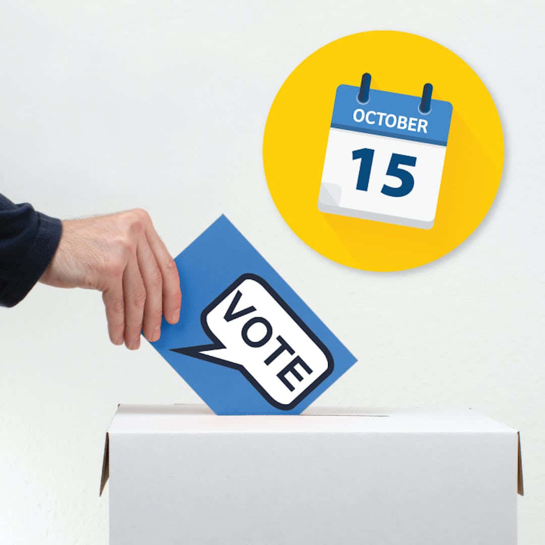 選舉 桌布 壁紙 — 一隻手將藍色選票放入一個白色盒子中，旁邊有一個帶有10月15日日曆圖標的黃色圓圈。