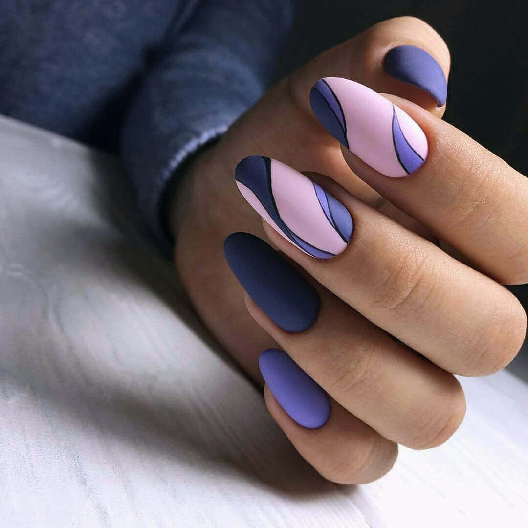 Spring Nails 桌布 壁紙 — 一隻手帶有霧面紫色和粉紅色抽象波浪指甲藝術，放在白色表面上。