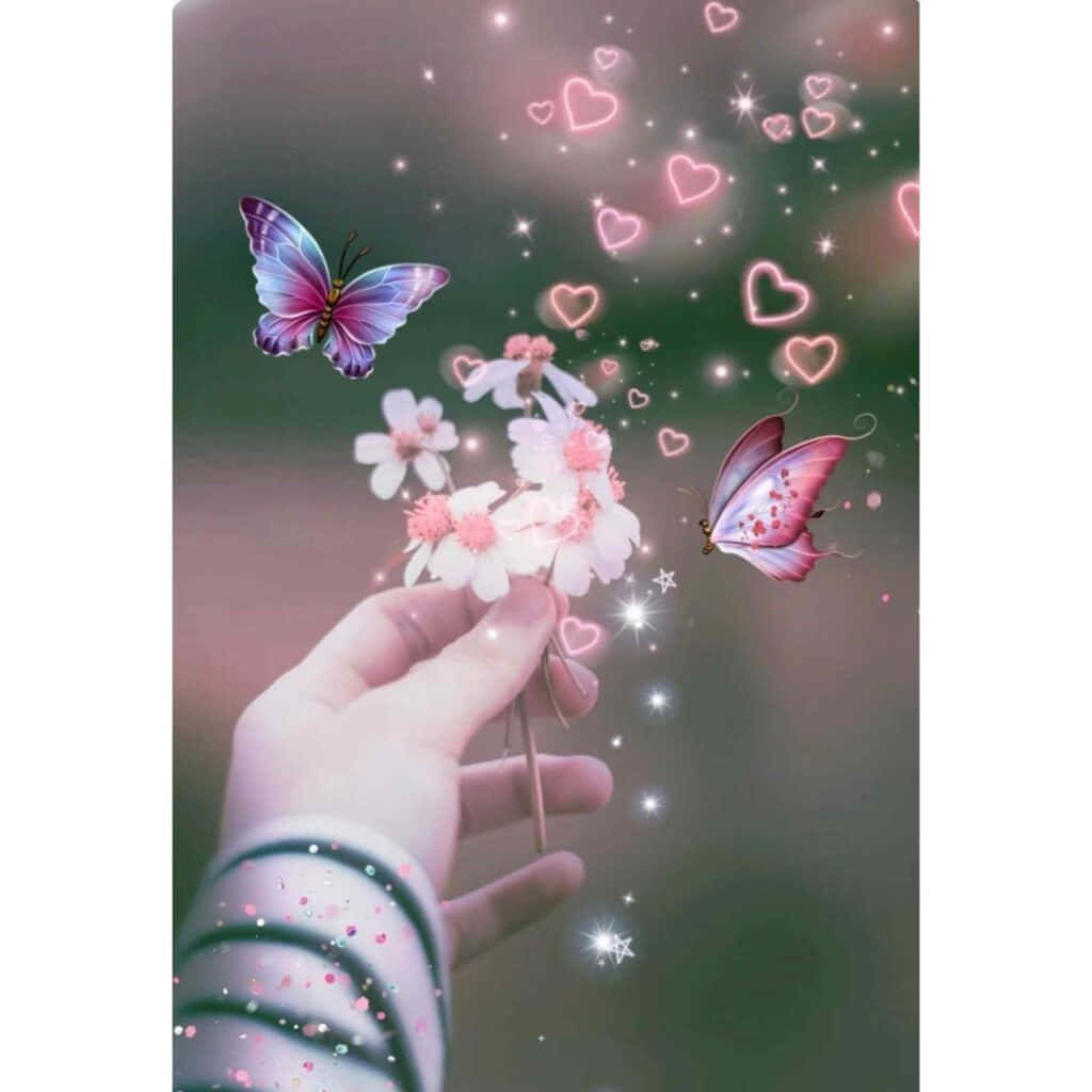 Butterflies 桌布 壁紙 — 一隻手拿著精緻的粉紅色花朵，發光的蝴蝶和心形閃光在夢幻般的奇幻場景中飛舞。