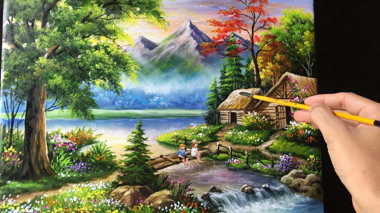 Beautiful Art 桌布 壁紙 — 一隻手正在繪製一幅充滿活力的風景畫，畫中有河邊小屋，周圍環繞著秋樹和遠山。