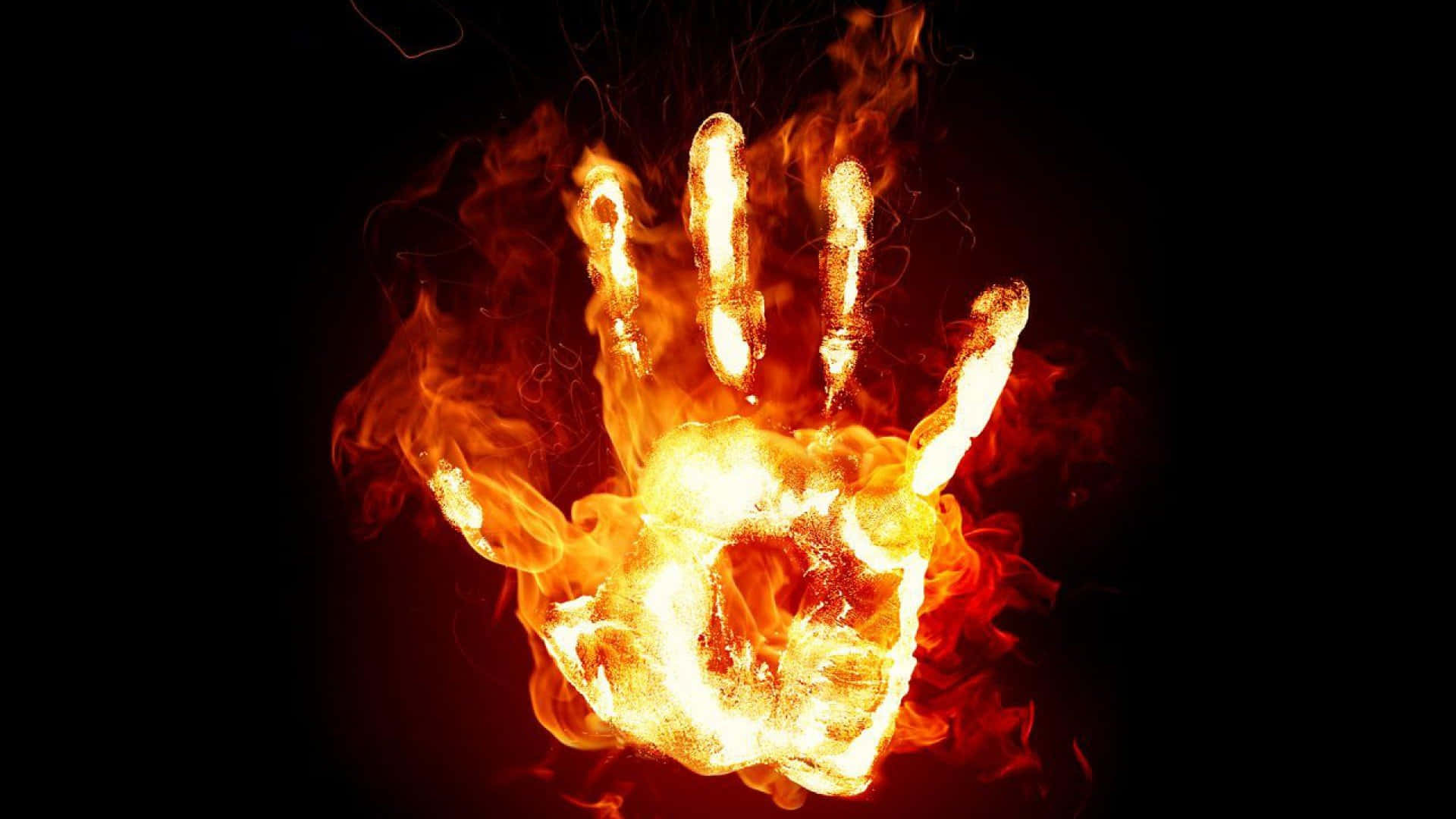 Flame 桌布 壁紙 — 一隻手被鮮豔的橙色和黃色火焰吞噬，背景為純黑色。