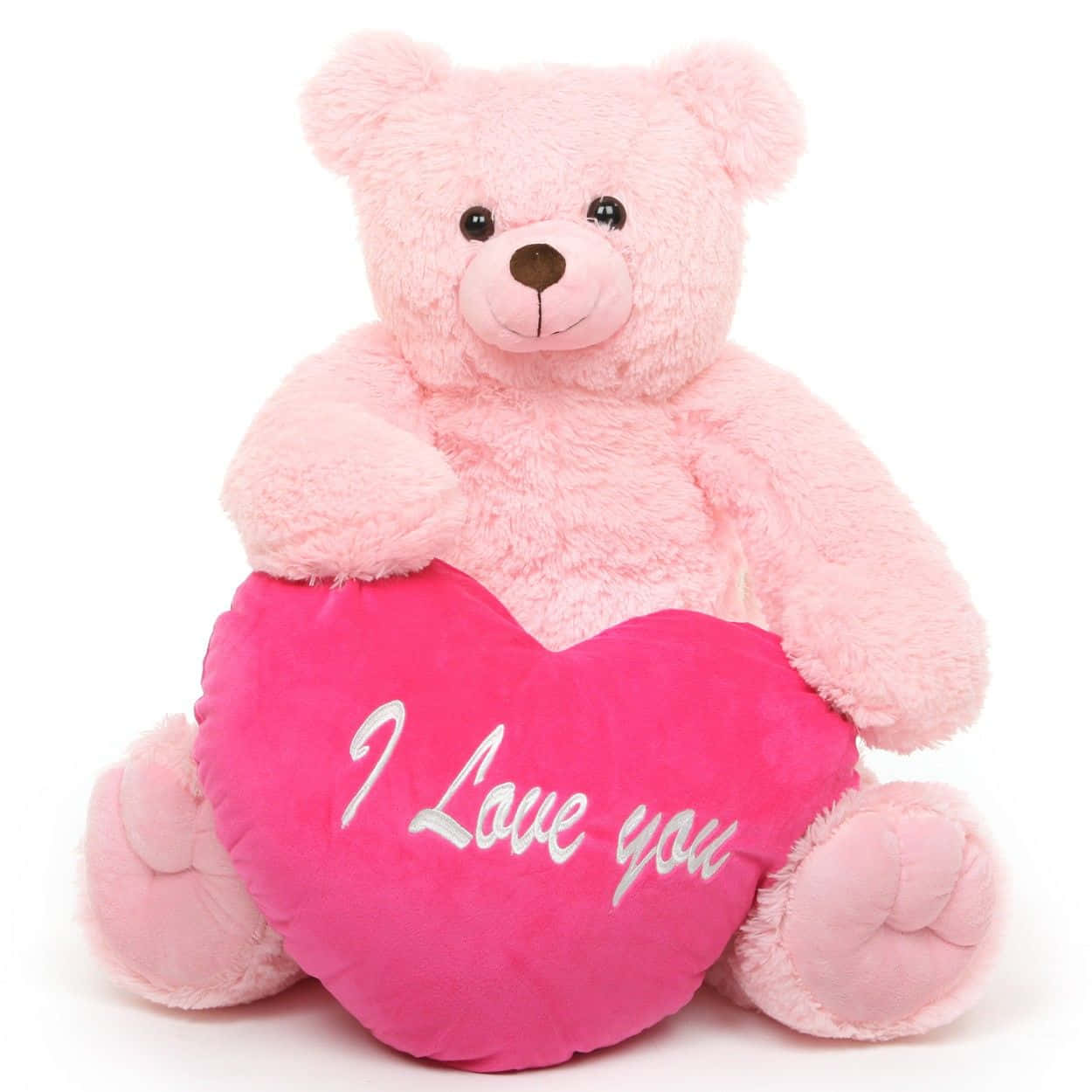 bear love 桌布 壁紙 — 一隻柔軟的粉紅色泰迪熊坐著，抱著一個繡有白色草書「I Love you」的亮粉紅色心形枕頭。
