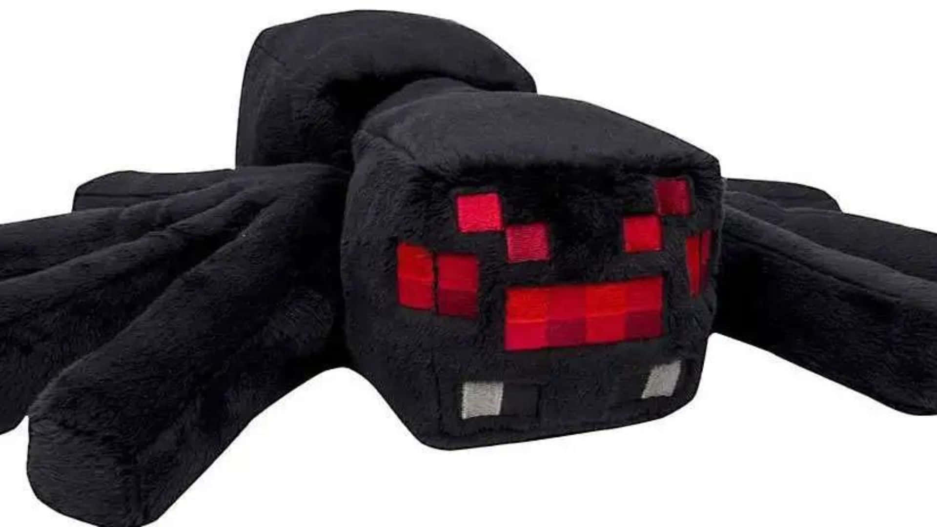 Minecraft Spider 桌布 壁紙 — 一隻柔軟的黑色毛絨蜘蛛，帶有像素化的紅色眼睛和銀色尖牙，躺在白色背景上。