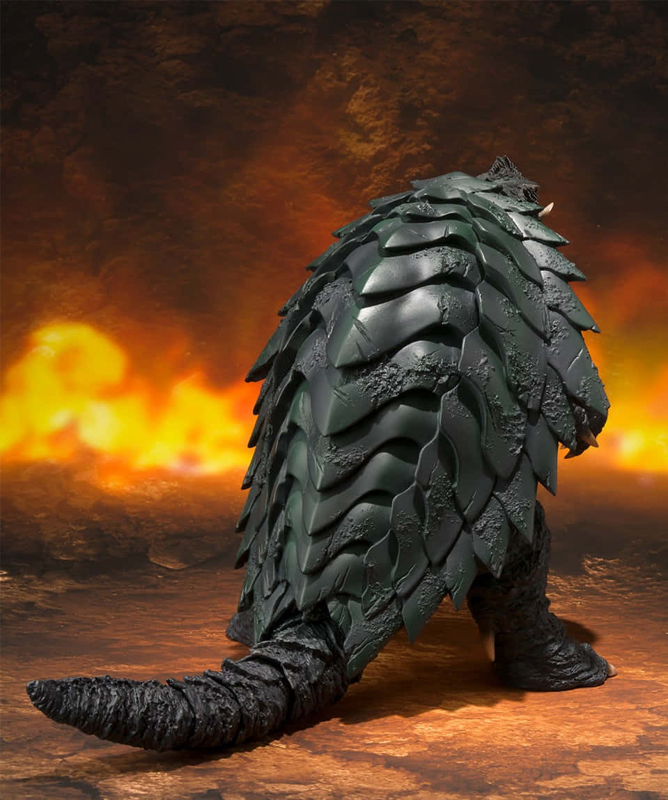 Gamera 桌布 壁紙 — 一隻深色鱗片怪物站在熾熱的風景中，背後有發光的橙色火焰。