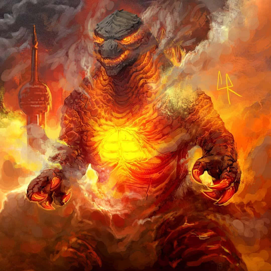 Burning Godzilla 桌布 壁紙 — 一隻火熱的哥吉拉在煙霧和火焰中咆哮，身後有一座城市塔樓正在燃燒。