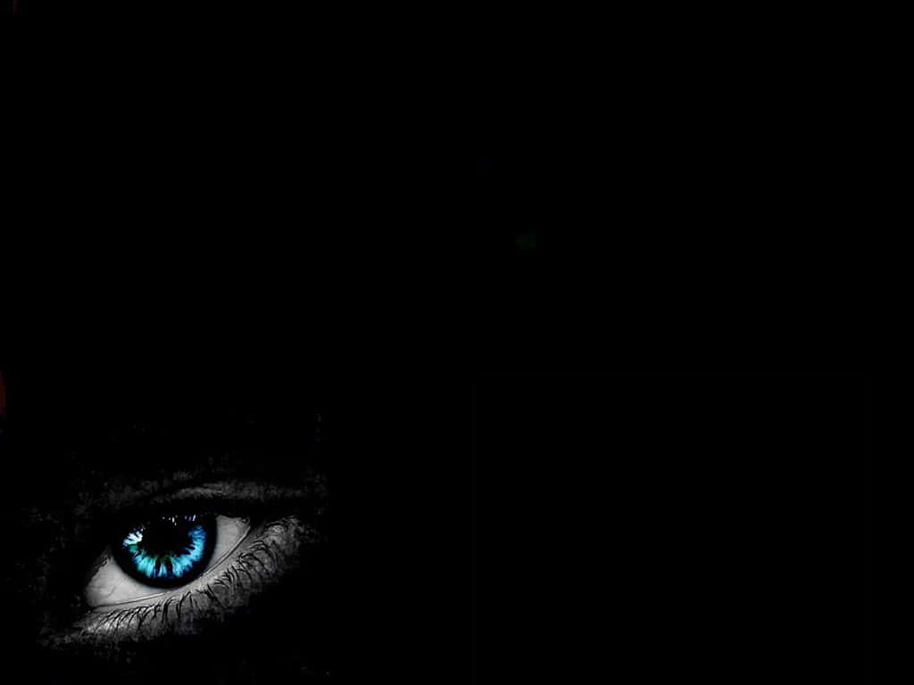 Eyes 桌布 壁紙 — 一隻發光的藍色眼睛從絕對的黑暗中強烈凝視，營造出令人毛骨悚然且神秘的氛圍。