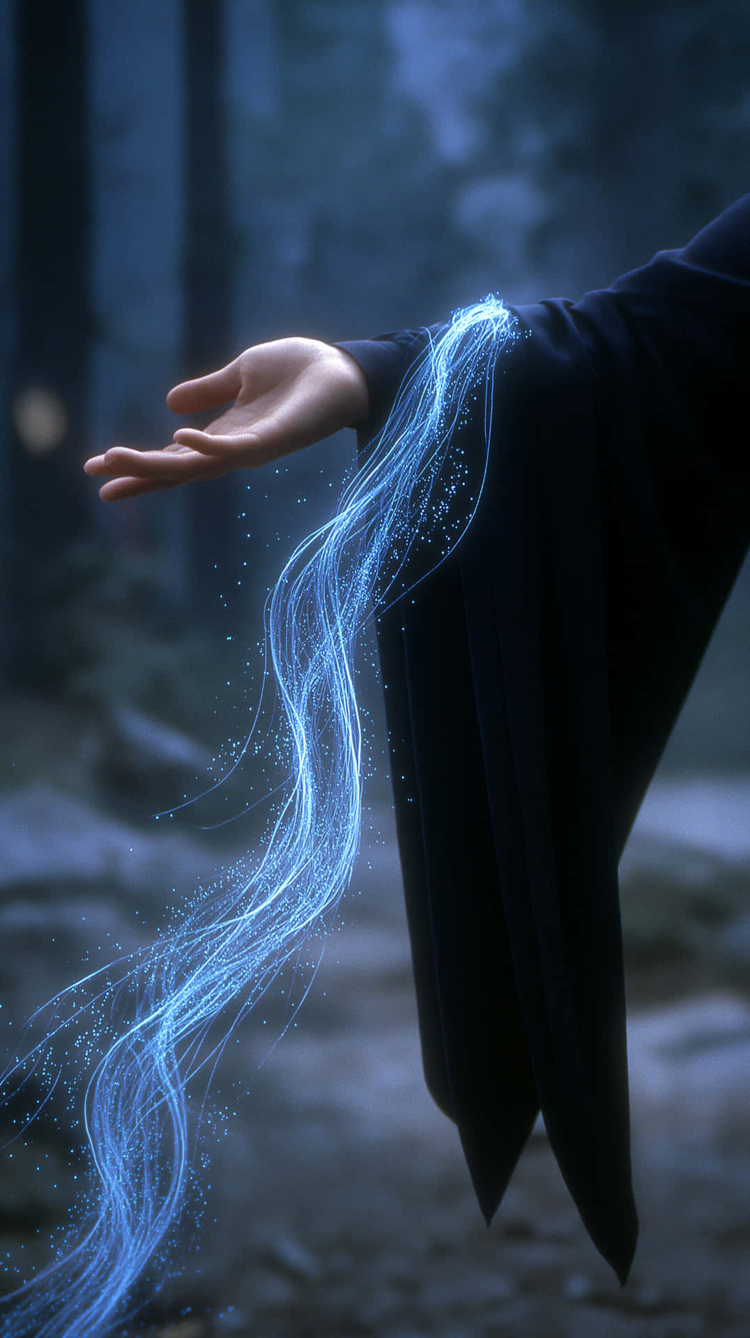 Hand Trailing Luminous Blue Energy Streaks in Forest 壁紙 — 一隻穿著深色長袍的手在暮色中的迷霧森林釋放出發光的藍色能量絲線。