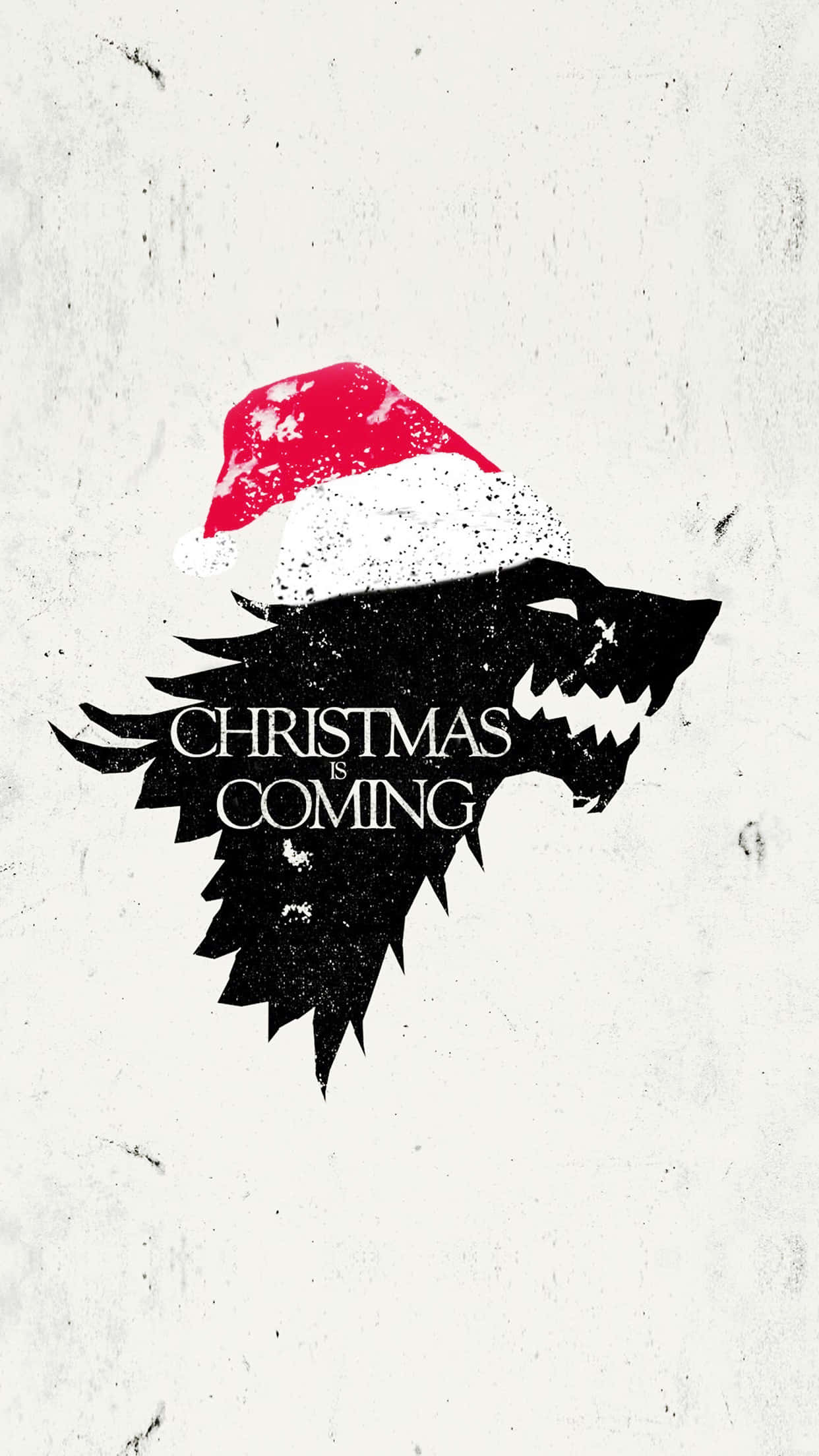 桌布 壁紙 — 一隻突出的黑狼頭戴著紅白聖誕帽，上面有文字 Christmas is Coming，背景是帶紋理的米白色。