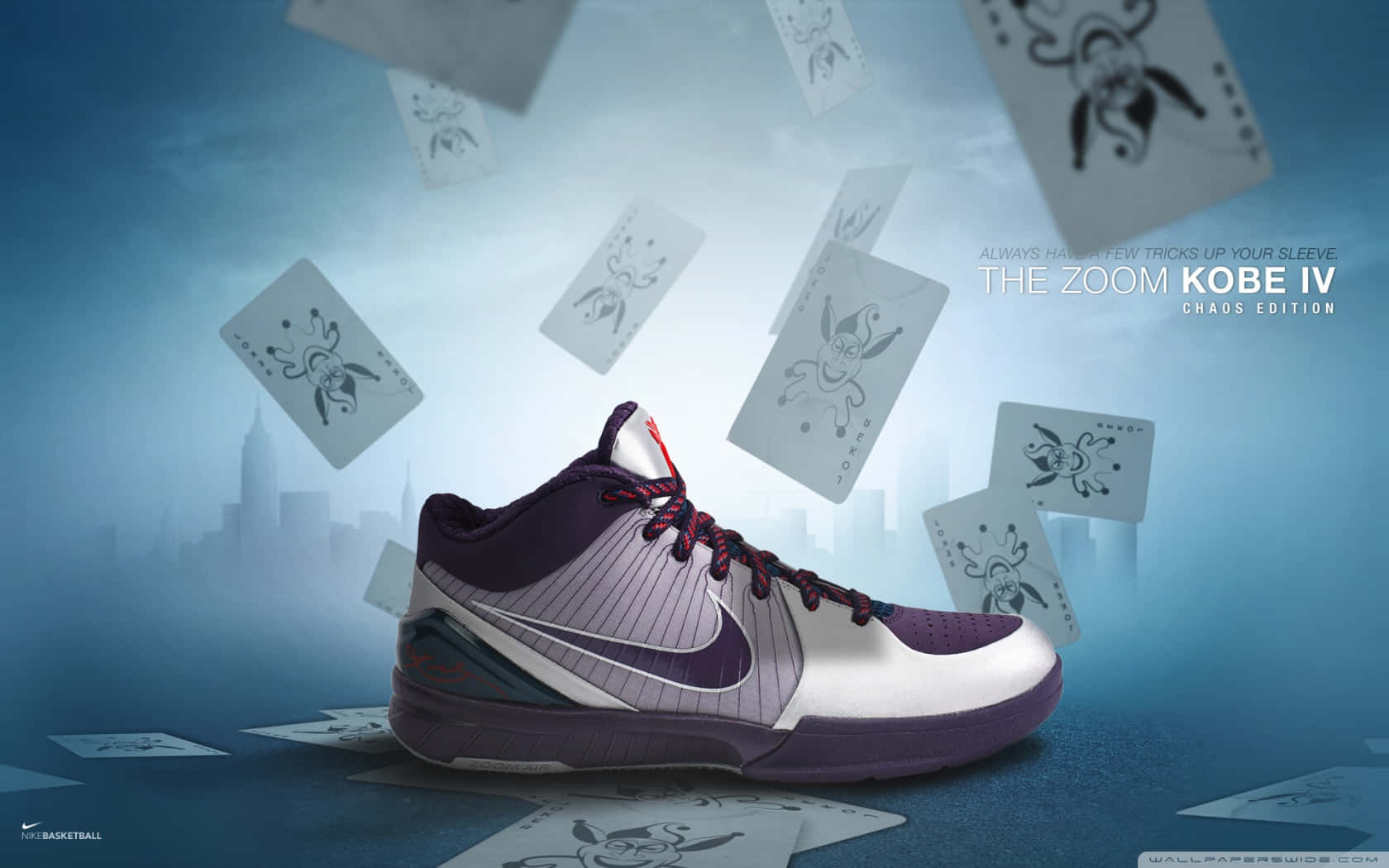 Nike 節奏籃球 桌布 壁紙 — 一隻紫白色的籃球鞋在涼爽的藍天下，於朦朧的城市天際線前，漂浮在落下的撲克牌之間。