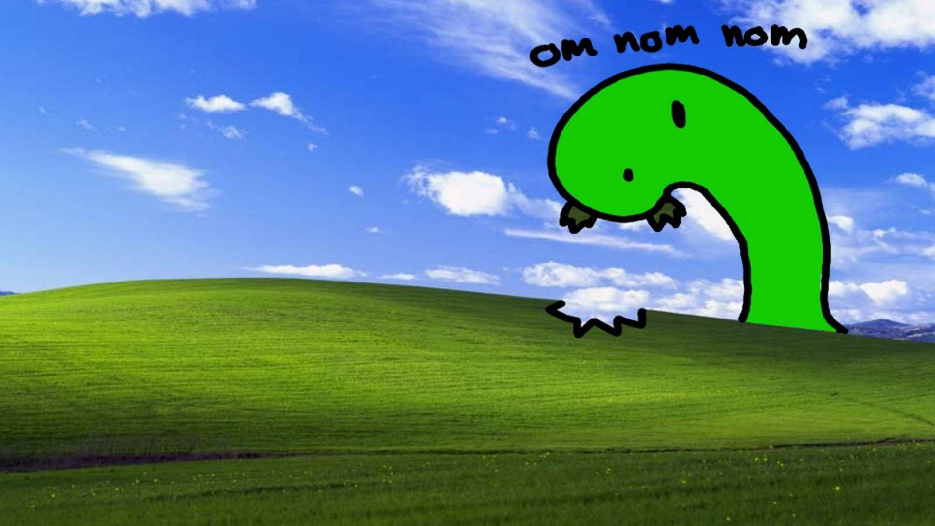 dank 桌布 壁紙 — 一隻綠色卡通恐龍，帶有「om nom nom」文字，在藍天白雲下起伏的綠色山丘上吃草。