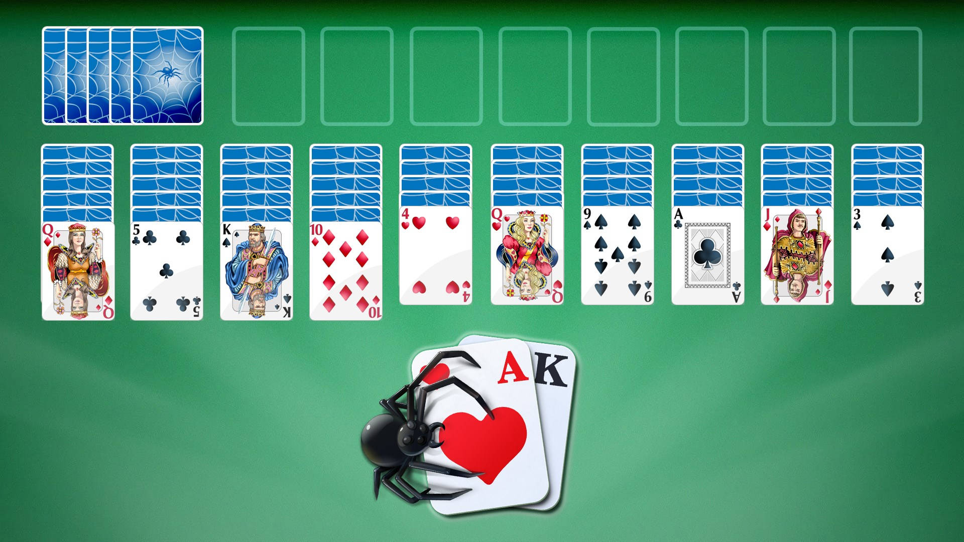 蜘蛛在綠色氈桌上的 Ace 和 King of Hearts 撲克牌上面。 — Microsoft 壁紙