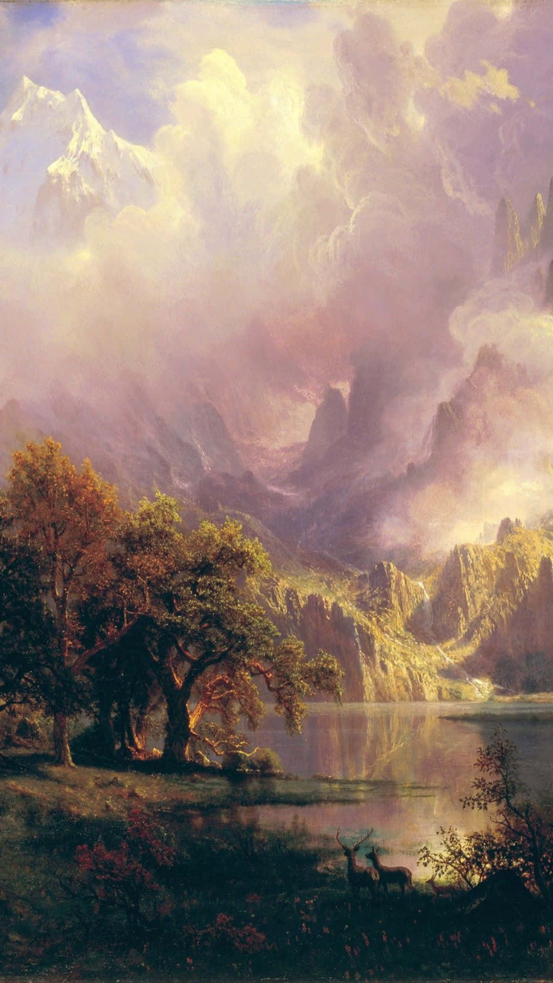 Renaissance 桌布 壁紙 — 一隻雄偉的鹿站在寧靜的湖邊，背後是高聳的山脈，沐浴在柔和的金色光芒中。