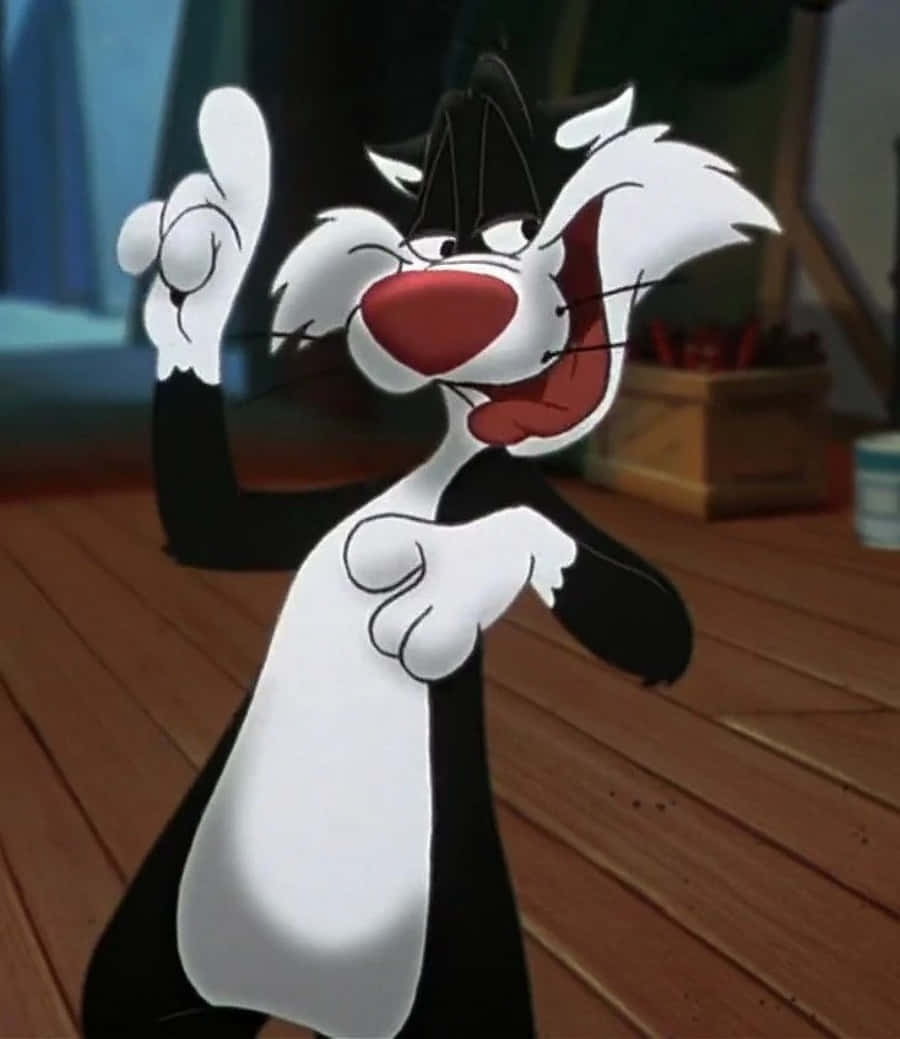 Sylvester The Cat 桌布 壁紙 — 一隻黑白毛色、紅鼻子的卡通貓站在木地板上，用一隻爪子愉快地揮手。