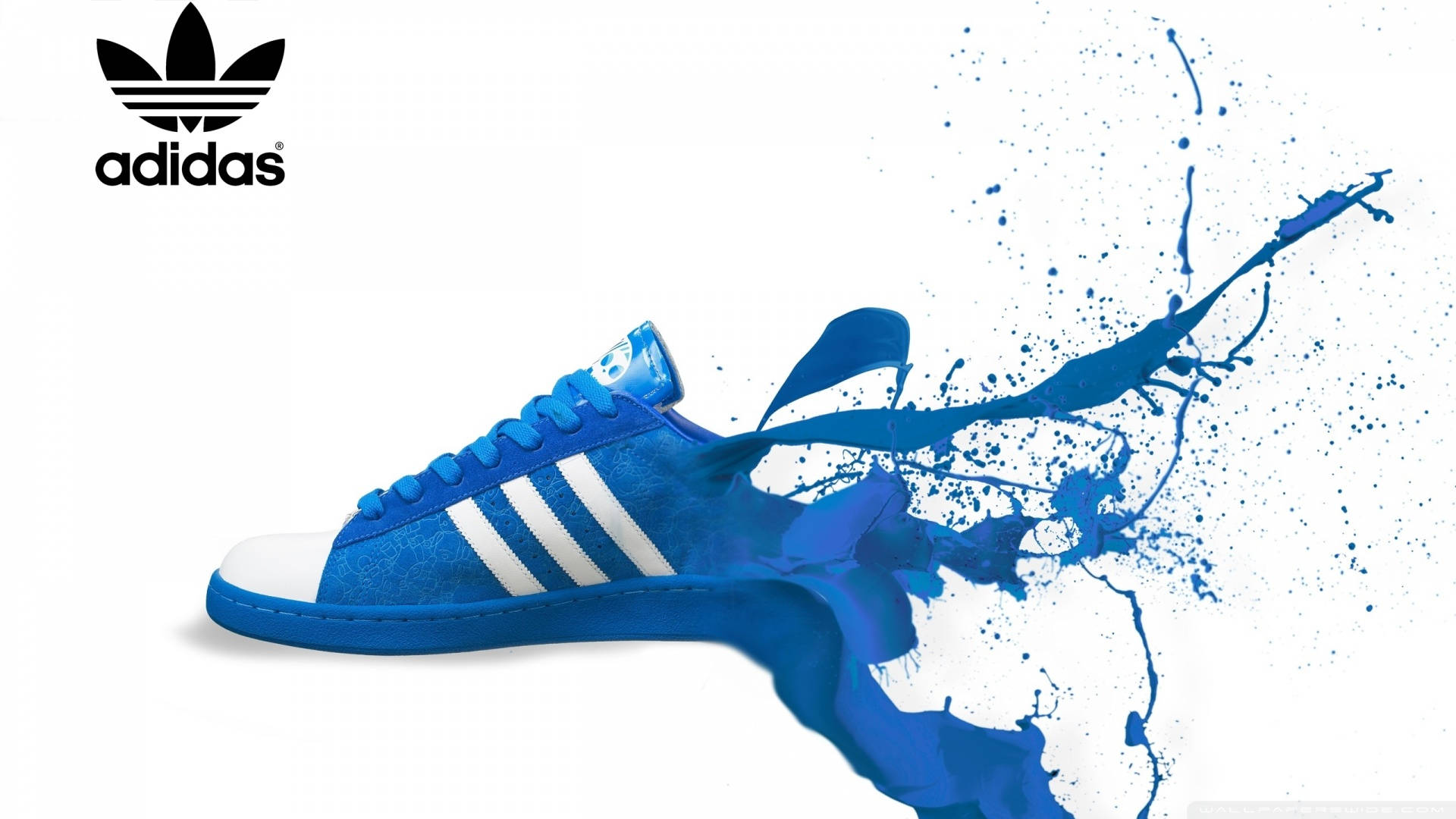 愛迪達 桌布 壁紙 — 一雙充滿活力的藍色 Adidas 運動鞋在純白背景上迸發出動態的顏料飛濺。