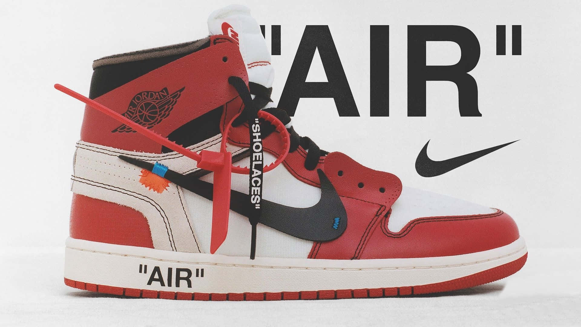 Off White Jordan 1 桌布 壁紙 — 一雙紅、白、黑色高筒運動鞋，帶有醒目品牌標誌和紅色鞋帶，背景為純白色。